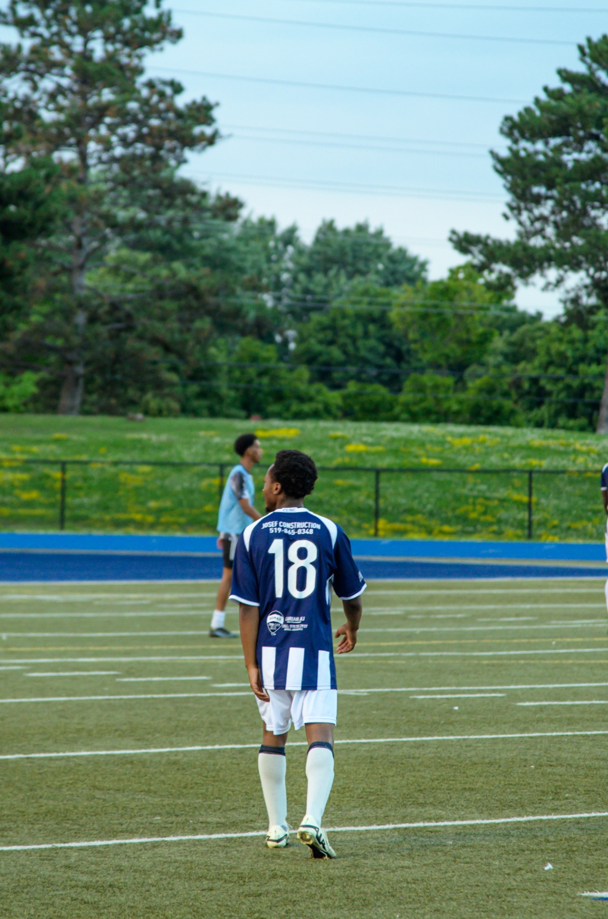Midfielder #18 pausing between plays