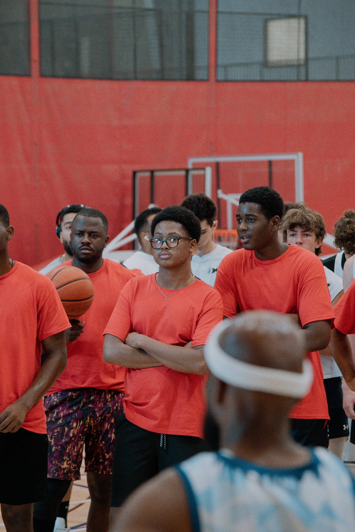 Red-shirt players spinning the ball before the coach's speech