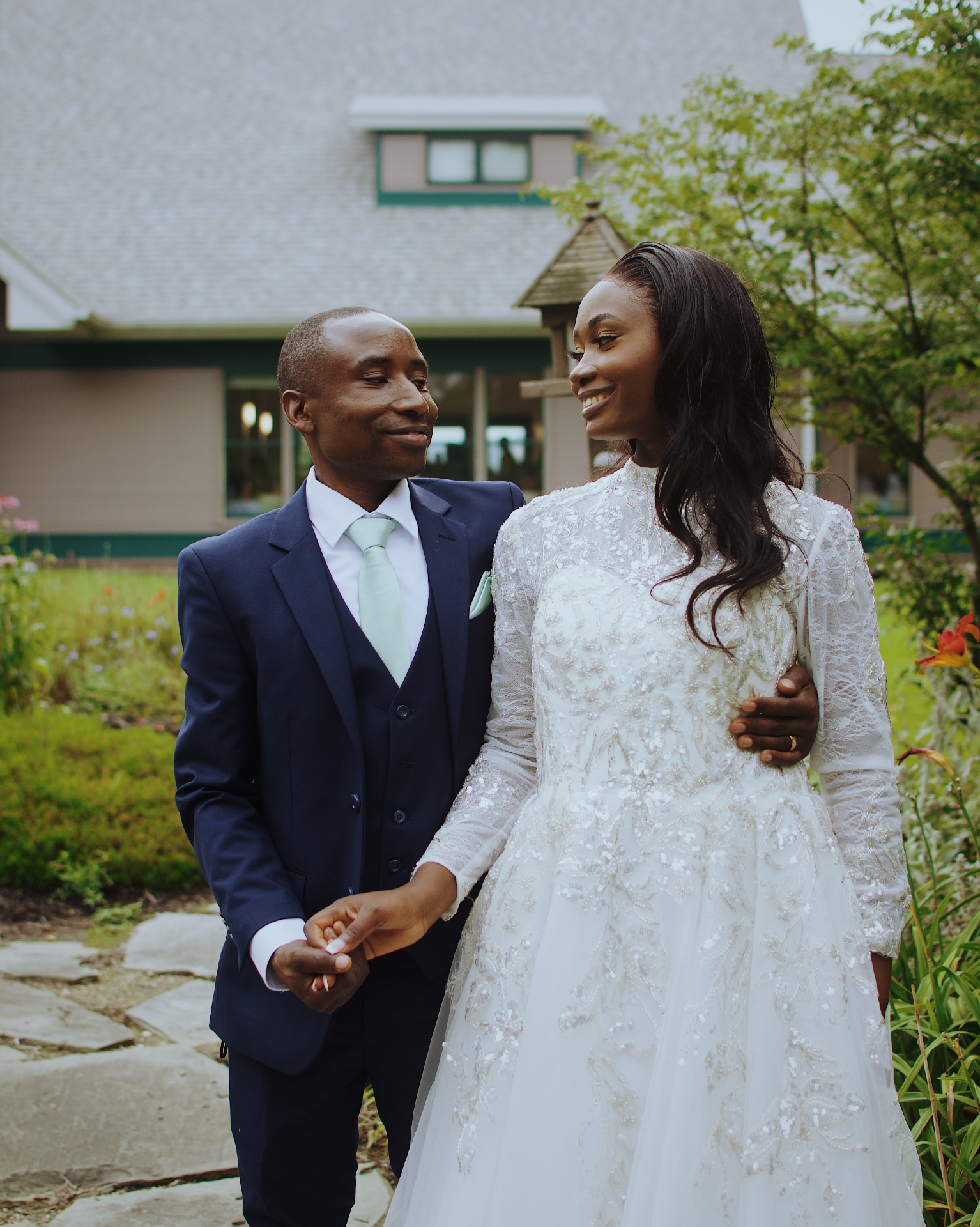 Bride and groom sharing a smile in the garden