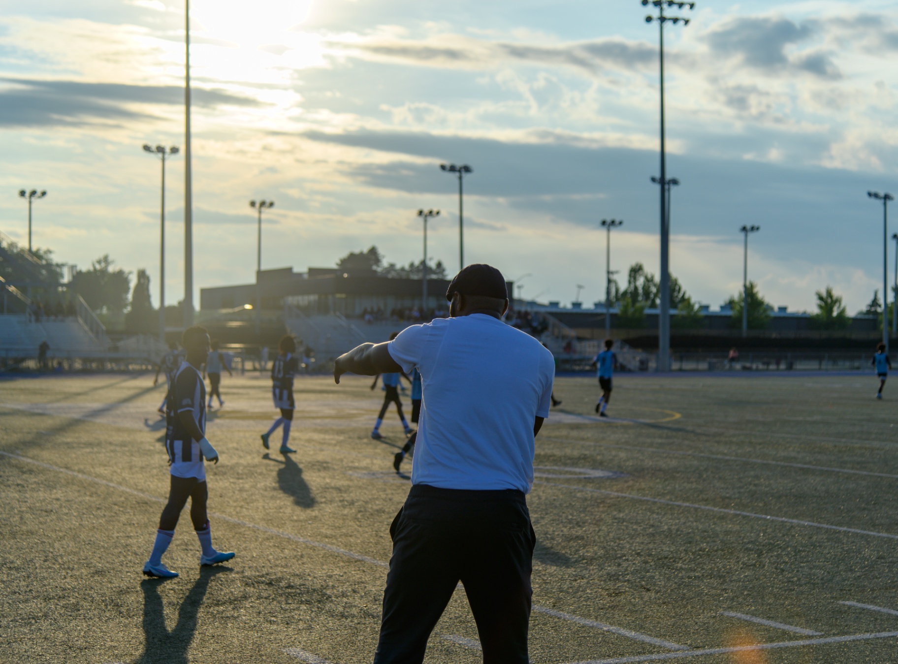 Coach directing the match at golden hour