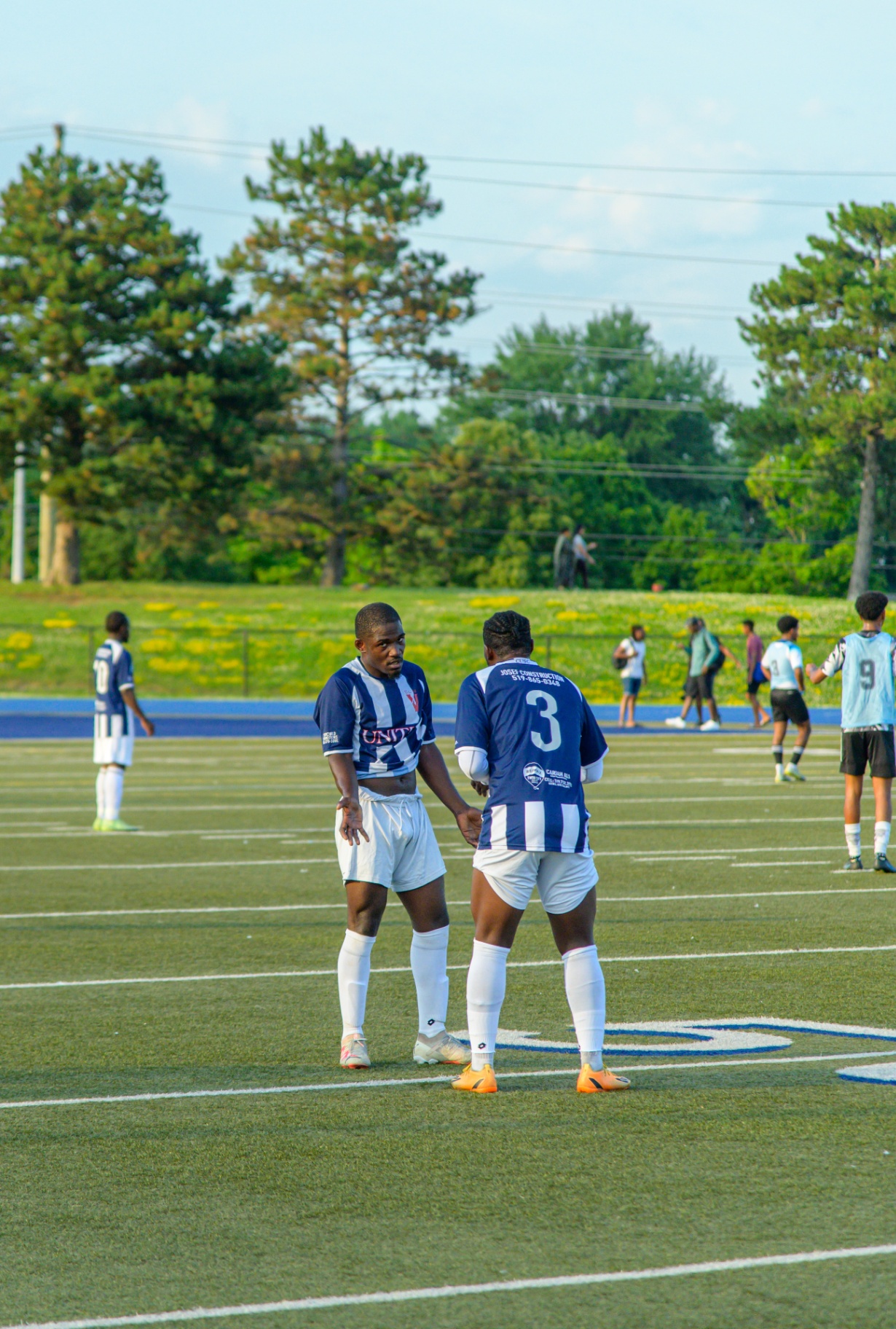 United FC teammates talking mid-match