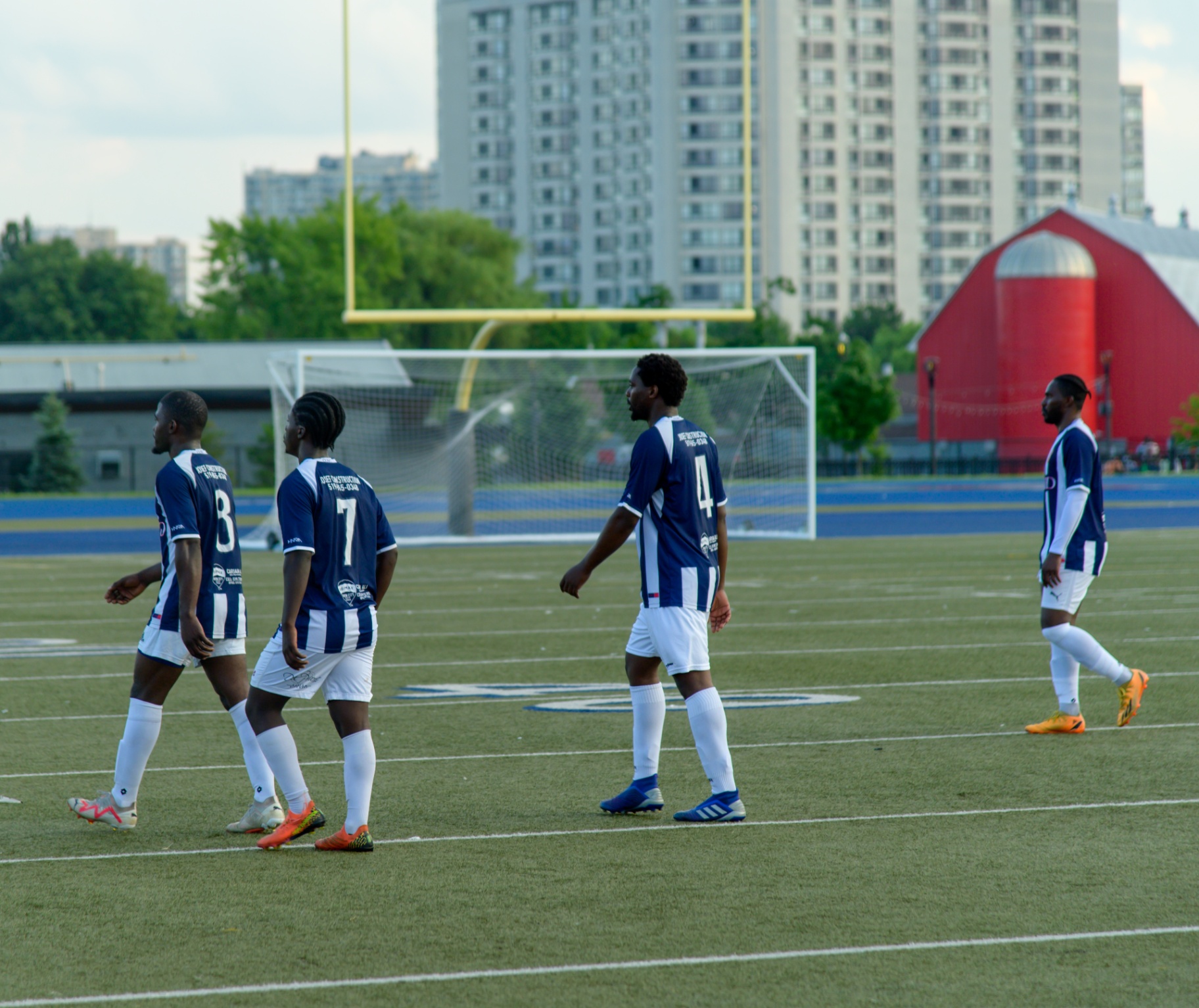 United FC squad walking up the pitch
