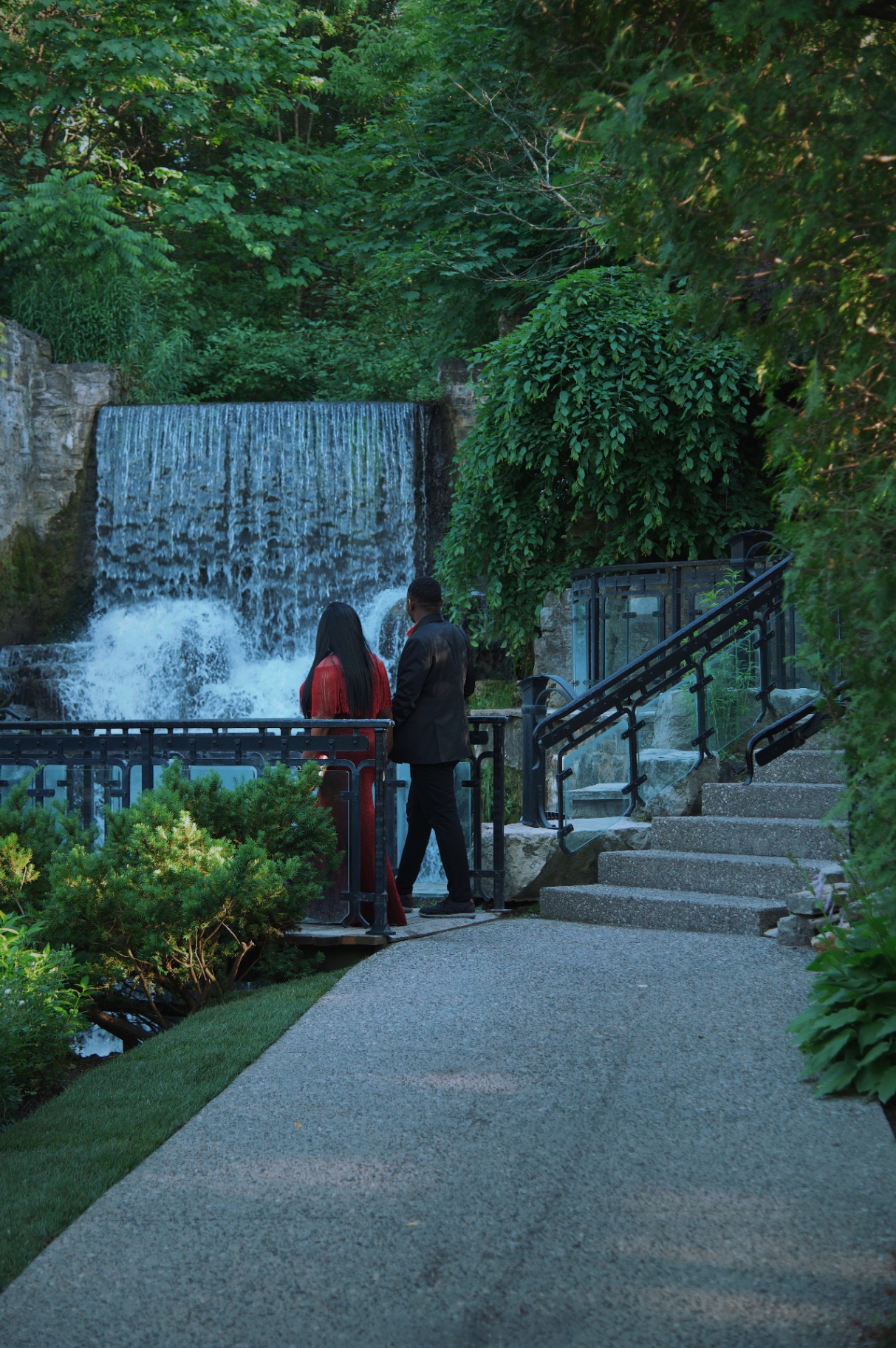 Couple gazing at the waterfall from the walkway