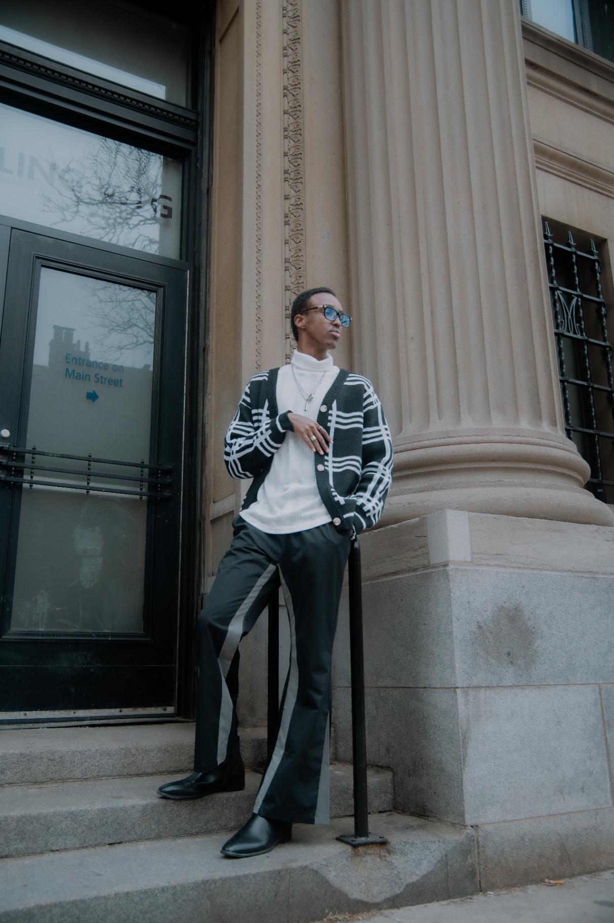 Leaning against a fluted column on Main Street