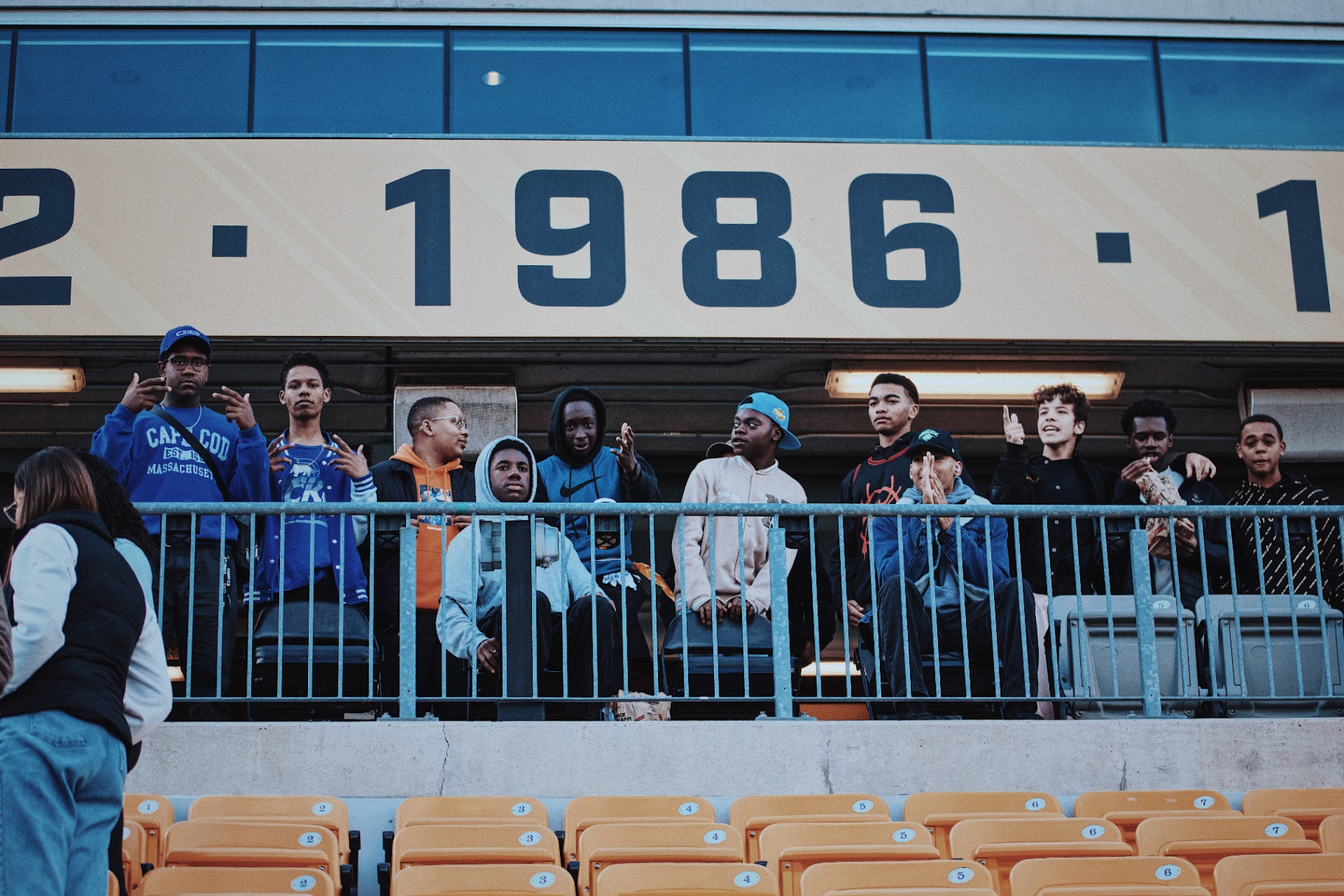 Fans in the stands under the 1986 banner