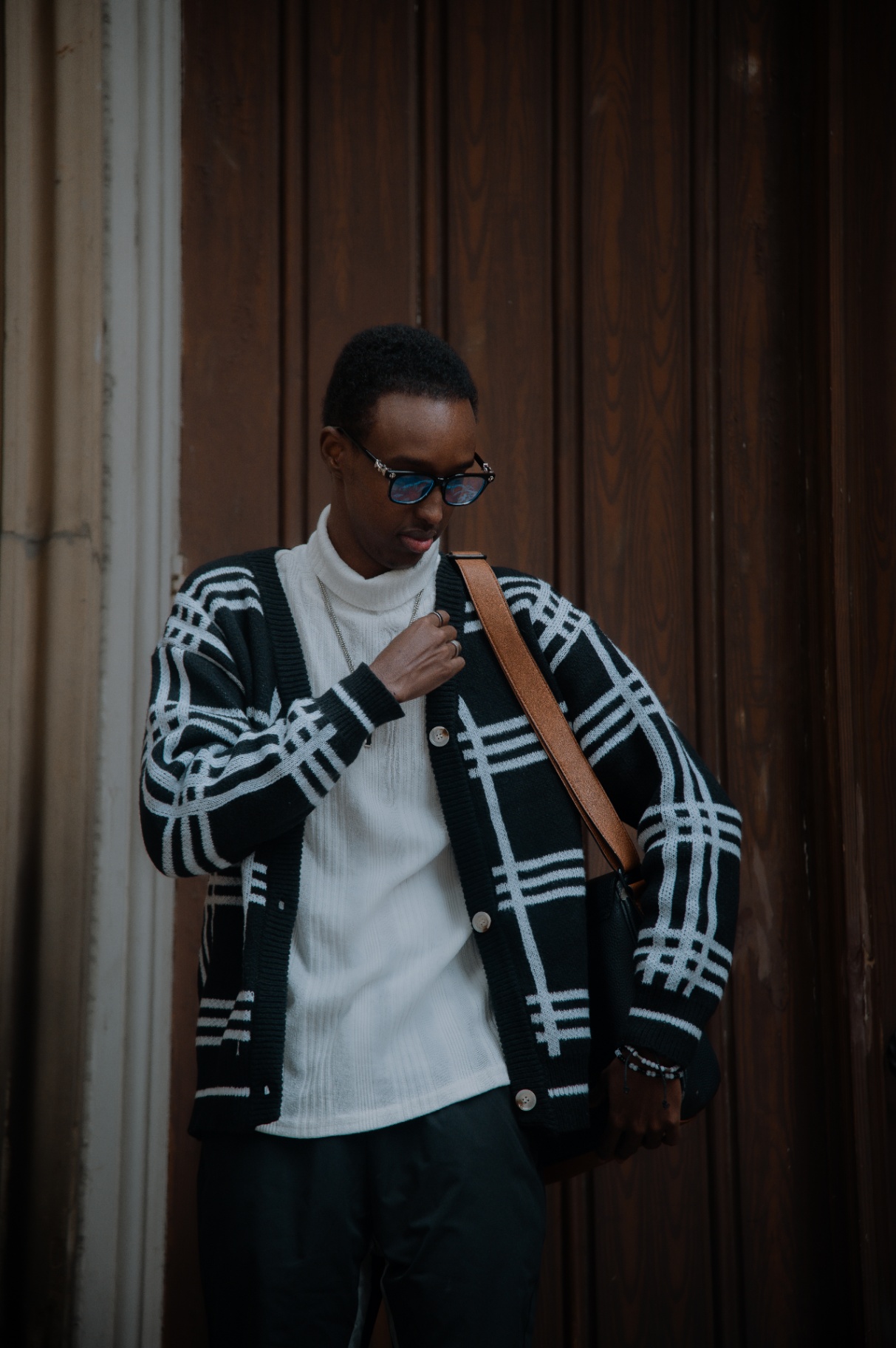 Candid street portrait with sunglasses and shoulder bag