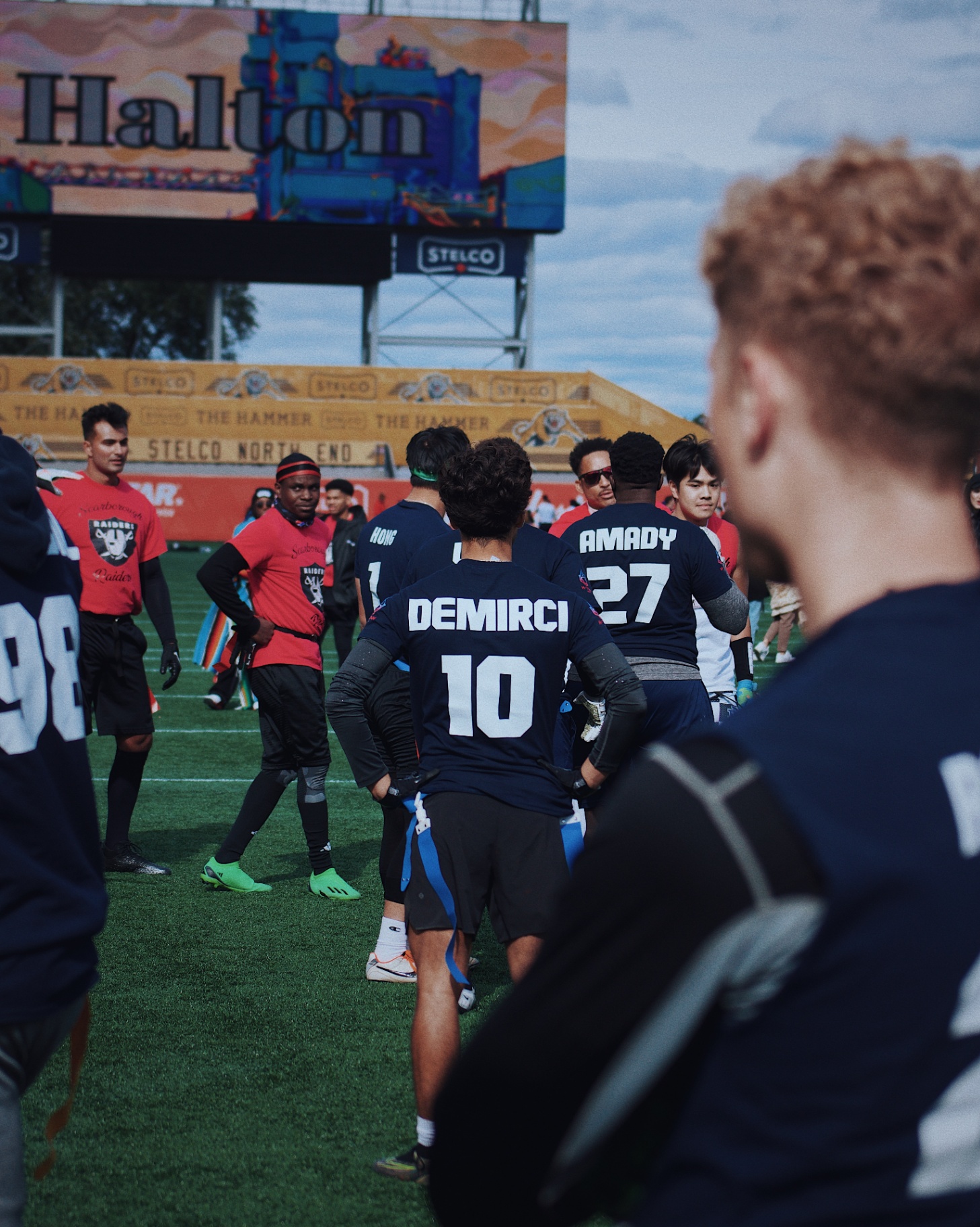 Teams gathering at Tim Hortons Field between plays