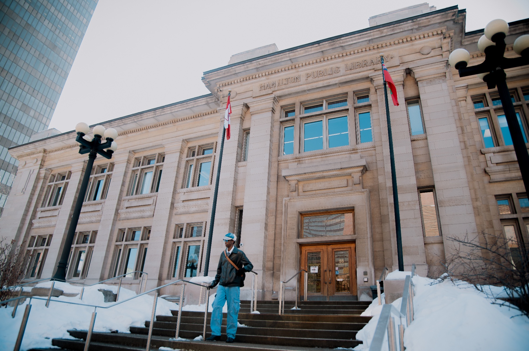 On the library steps in a cap and leather jacket