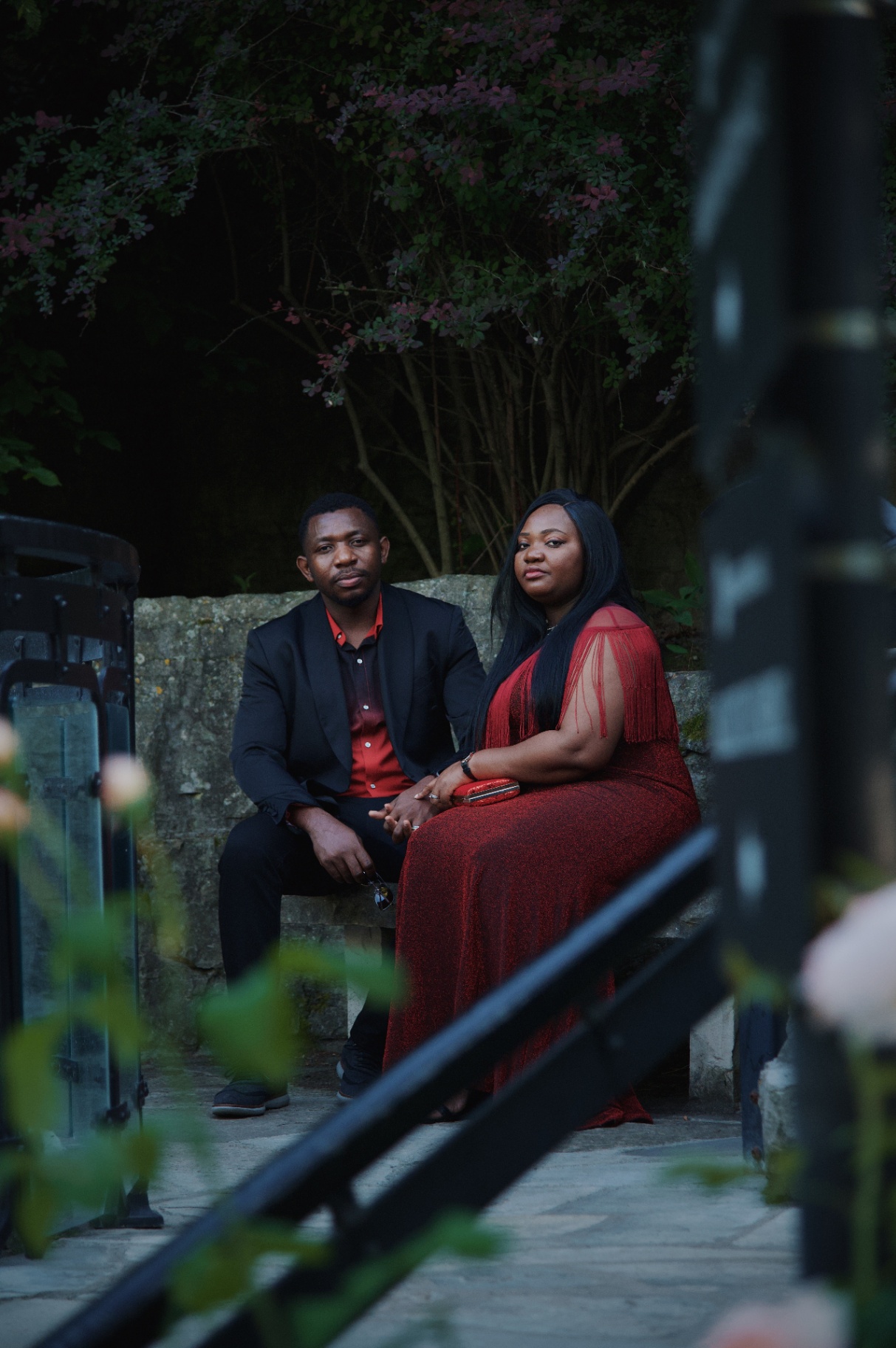 Editorial portrait of the couple seated in the garden