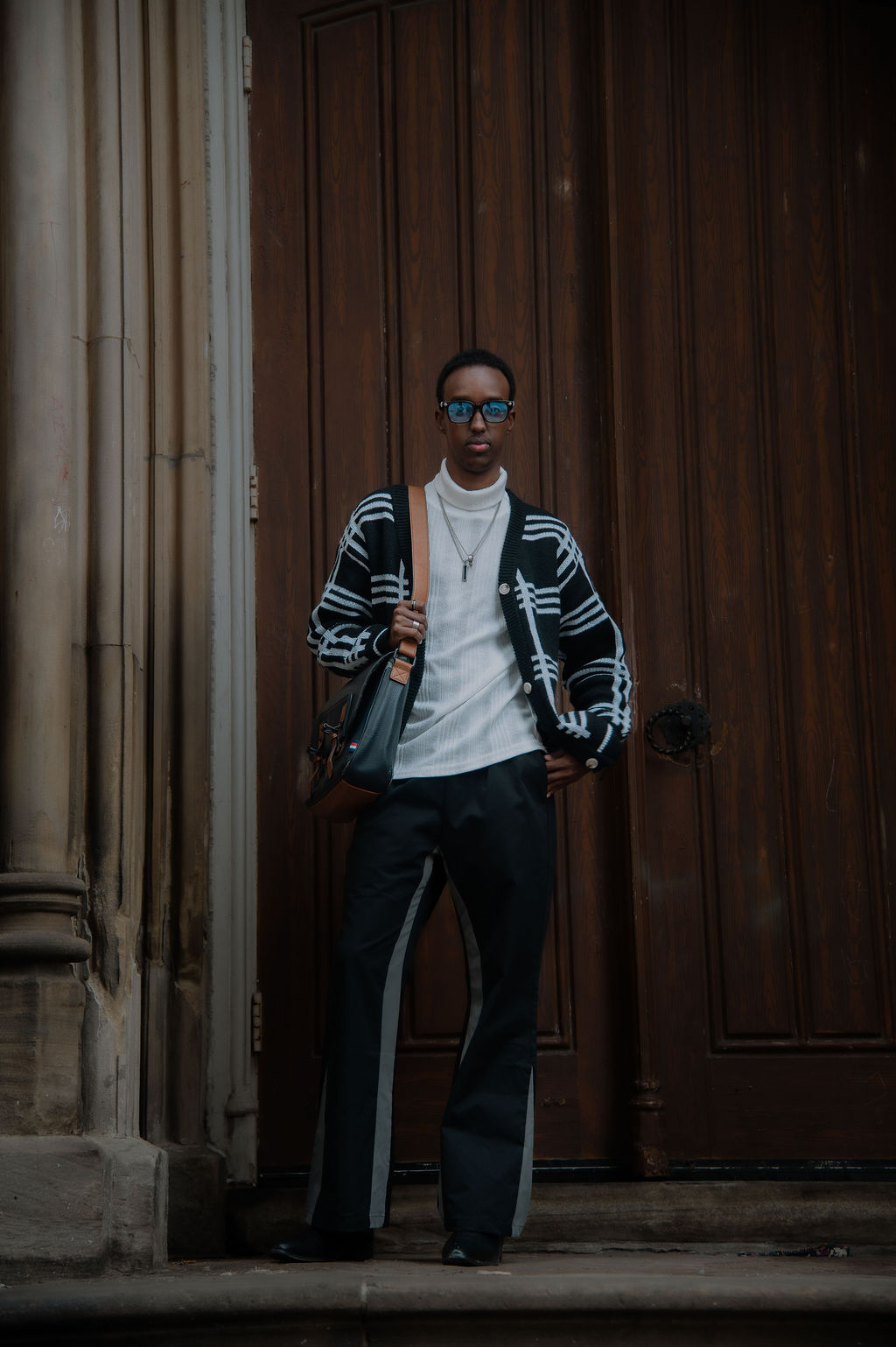 Portrait by a grand wooden doorway