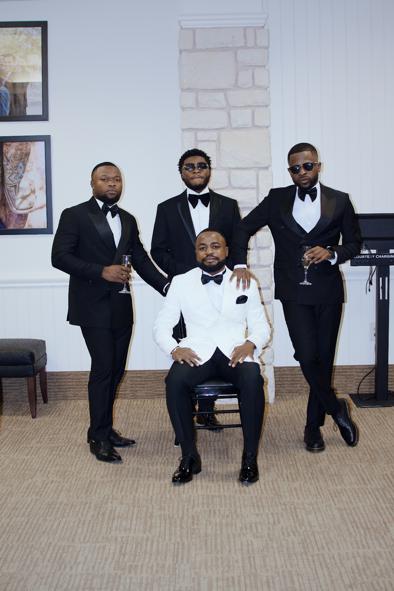 Groom seated with groomsmen in classic black tie