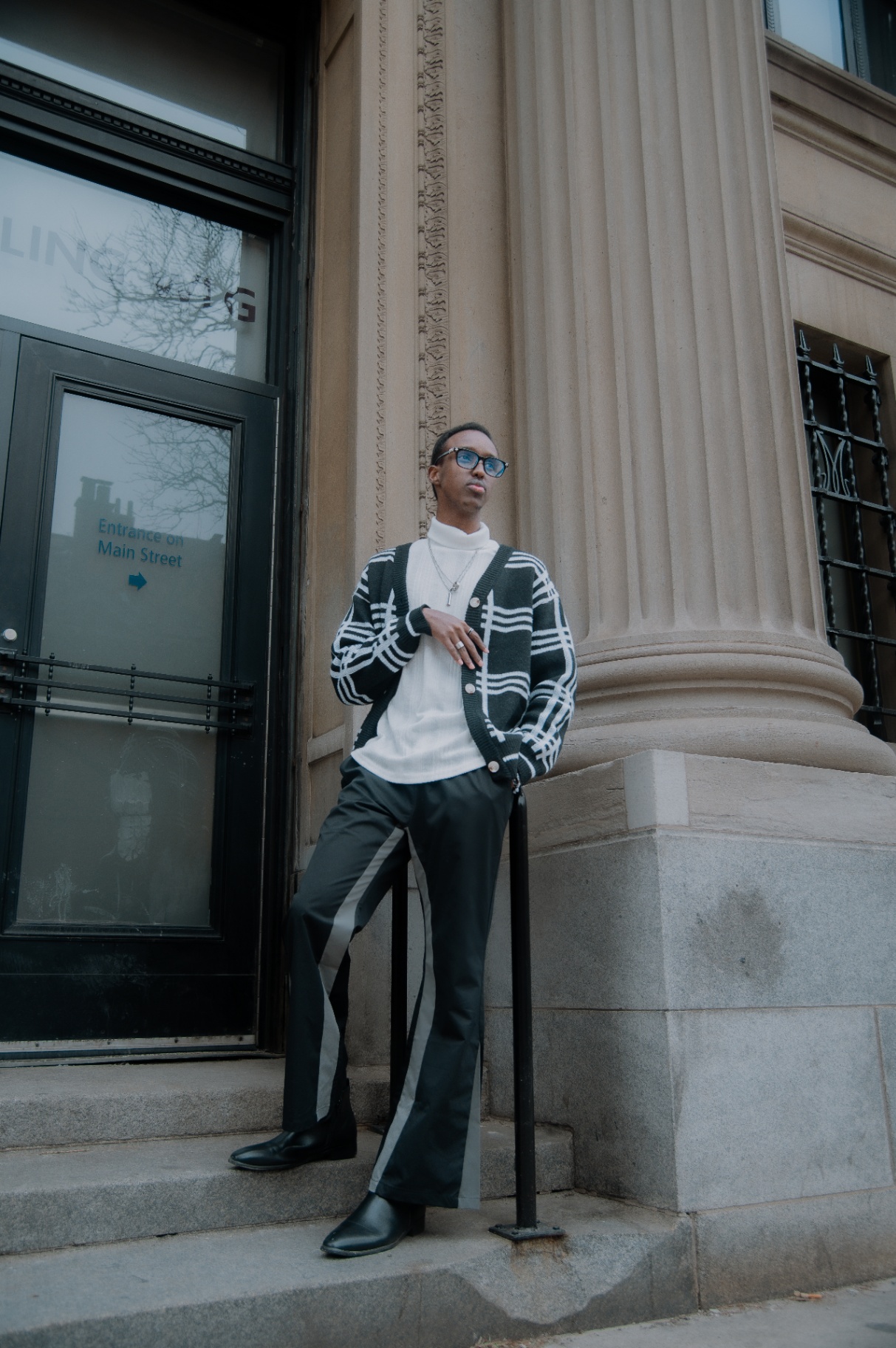 Street portrait on the steps beside a stone column