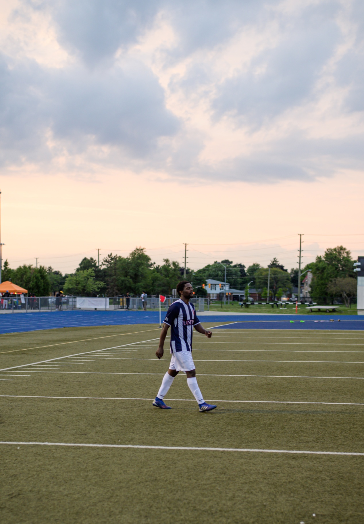 United FC player walking off the pitch at sunset
