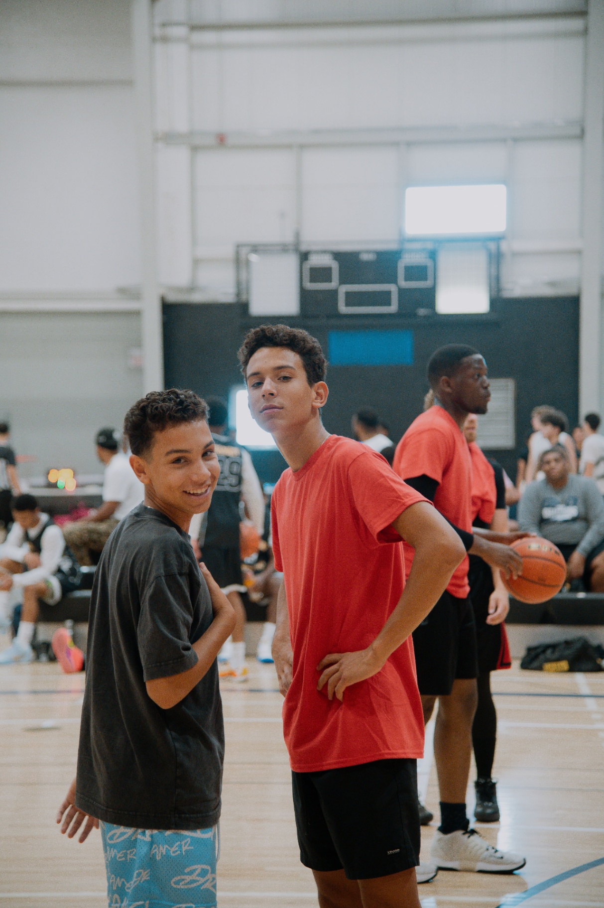 Teammates smiling on the sideline before tip-off