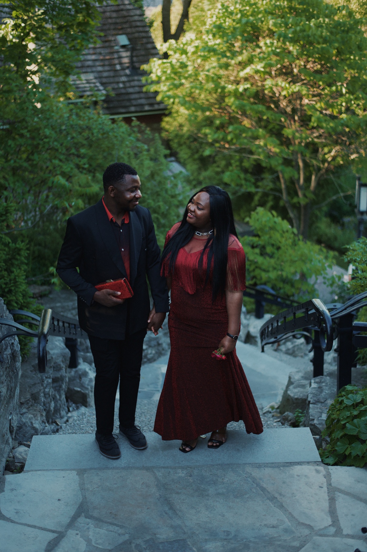 Couple in red and black descending the garden stairs