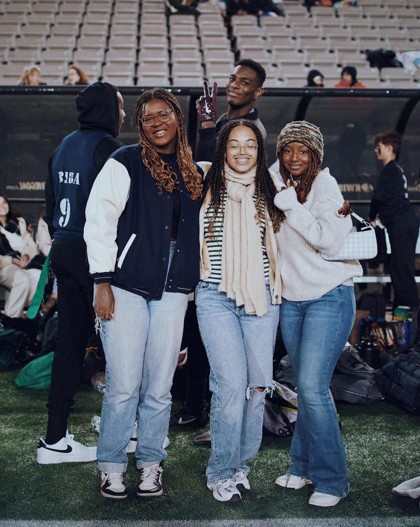Friends posing on the sideline after the flag football game