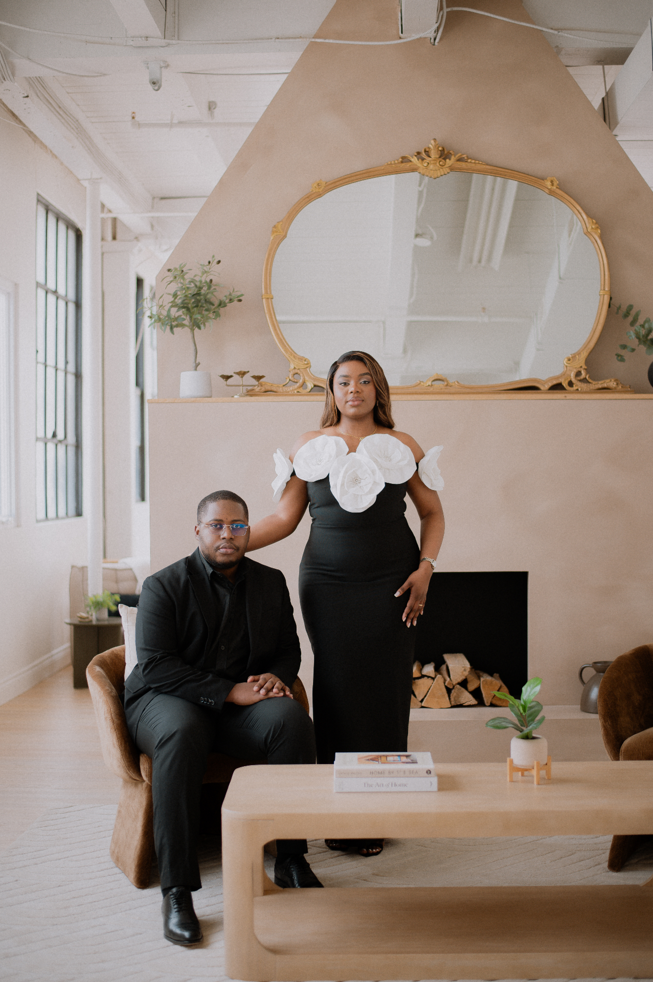 Editorial studio portrait in black formalwear with gilded mirror