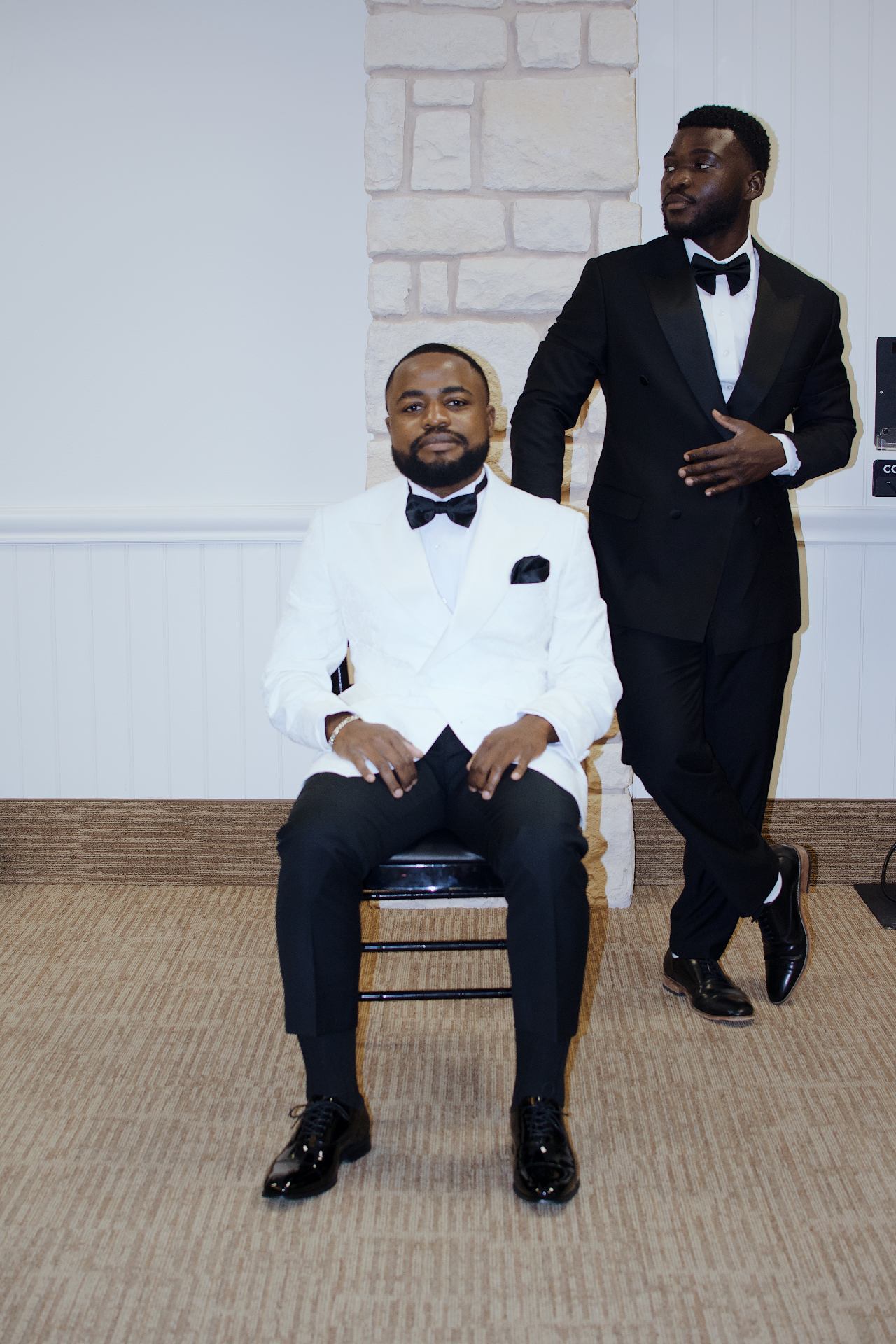 Groom in white tuxedo with his best man