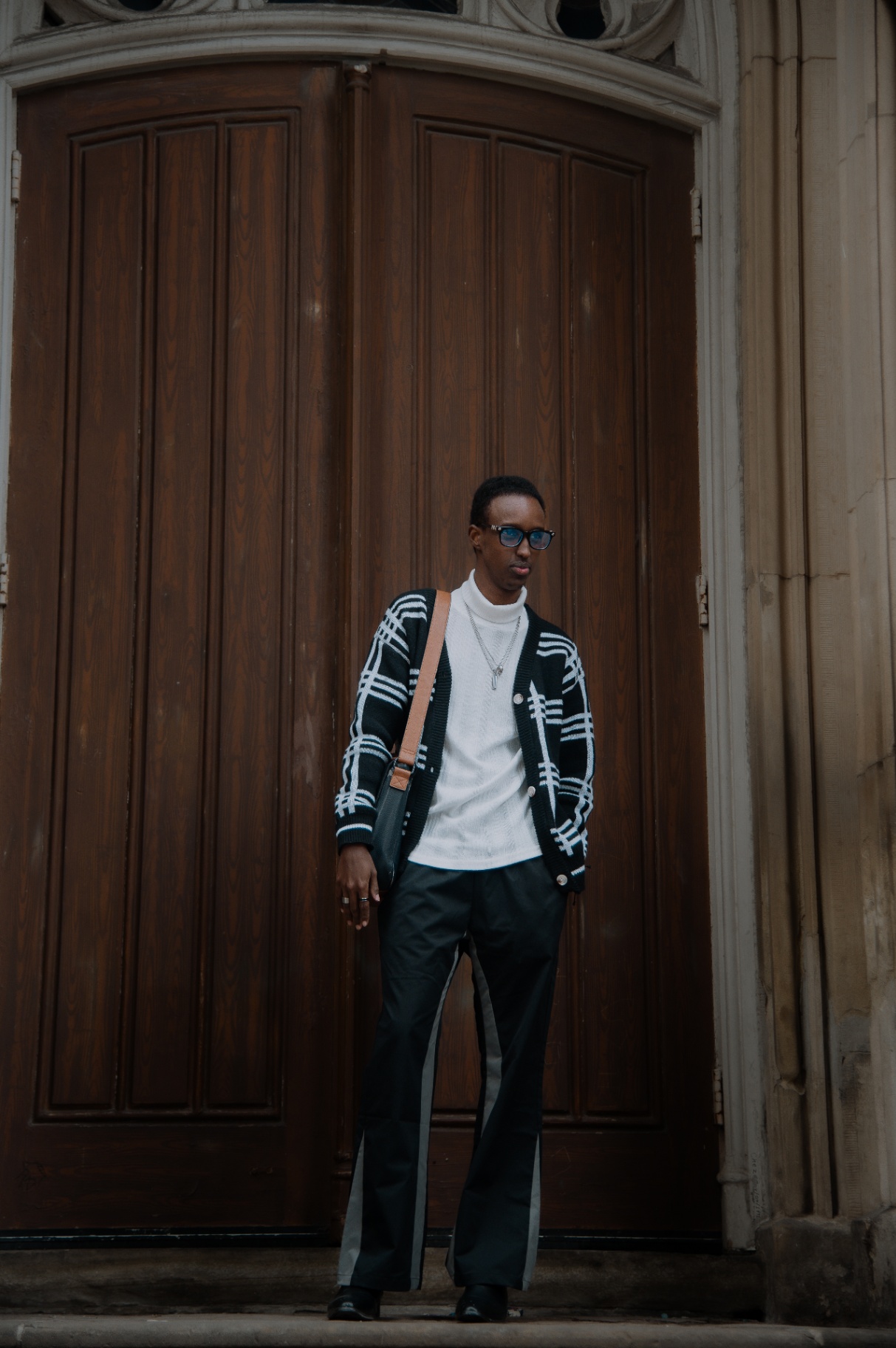Street portrait centered under an arched wooden doorway
